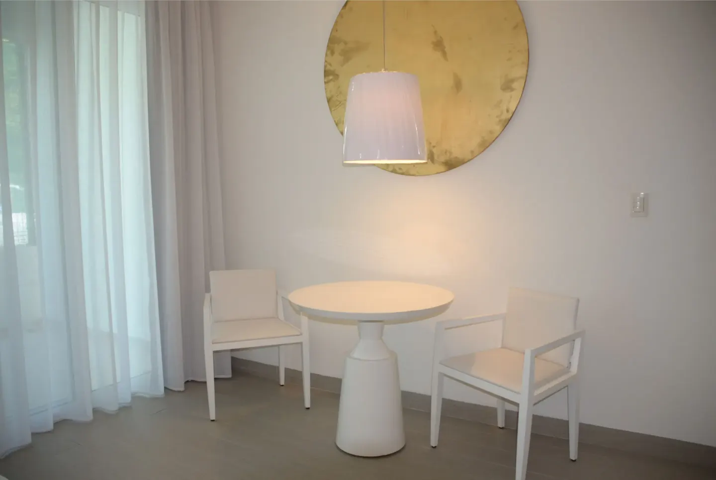 Junior Suite dining nook with round table and two chairs at Platinum Yucatan Princess.