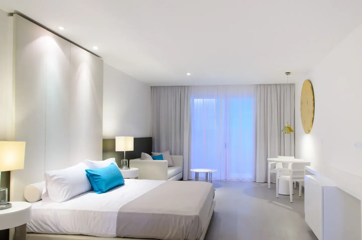 Junior Suite king bed with sofa and dining area at Platinum Yucatan Princess.