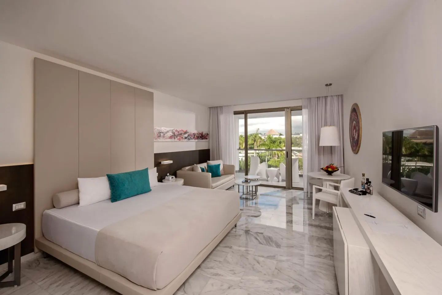 Junior Suite with king bed, sofa, balcony, and TV at Platinum Yucatan Princess.
