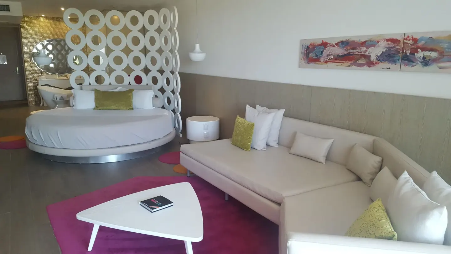 Round bed suite with lounge sofa and white divider at Platinum Yucatan Princess.