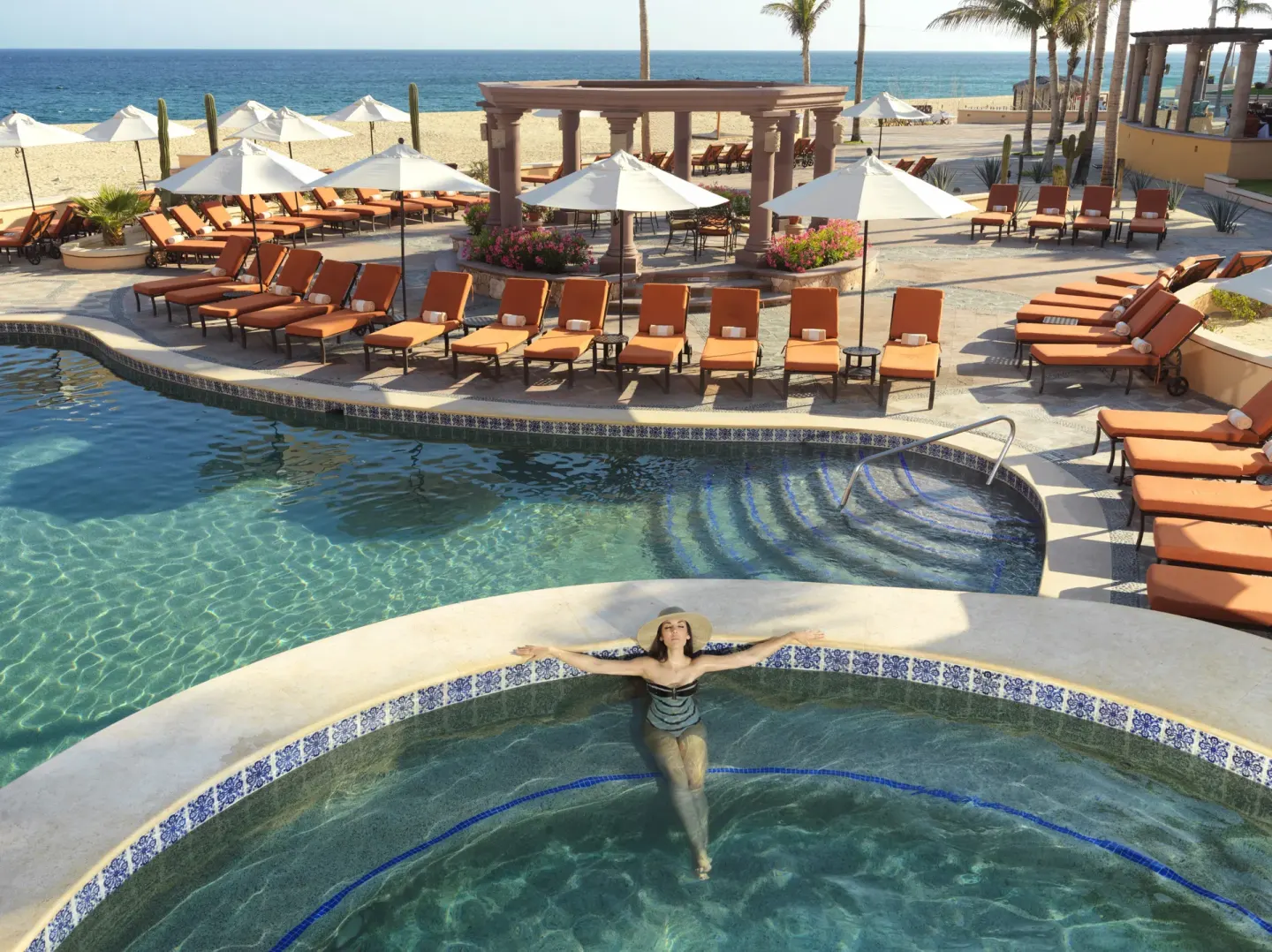 Guest relaxing in a round spa pool by the beach at Playa Grande Resort & Grand Spa.
