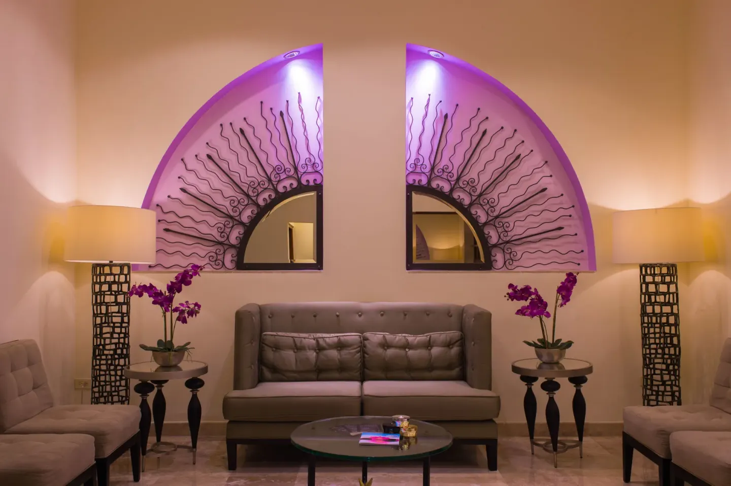 Lounge seating with purple-lit wall decor at Playa Grande Resort & Grand Spa.