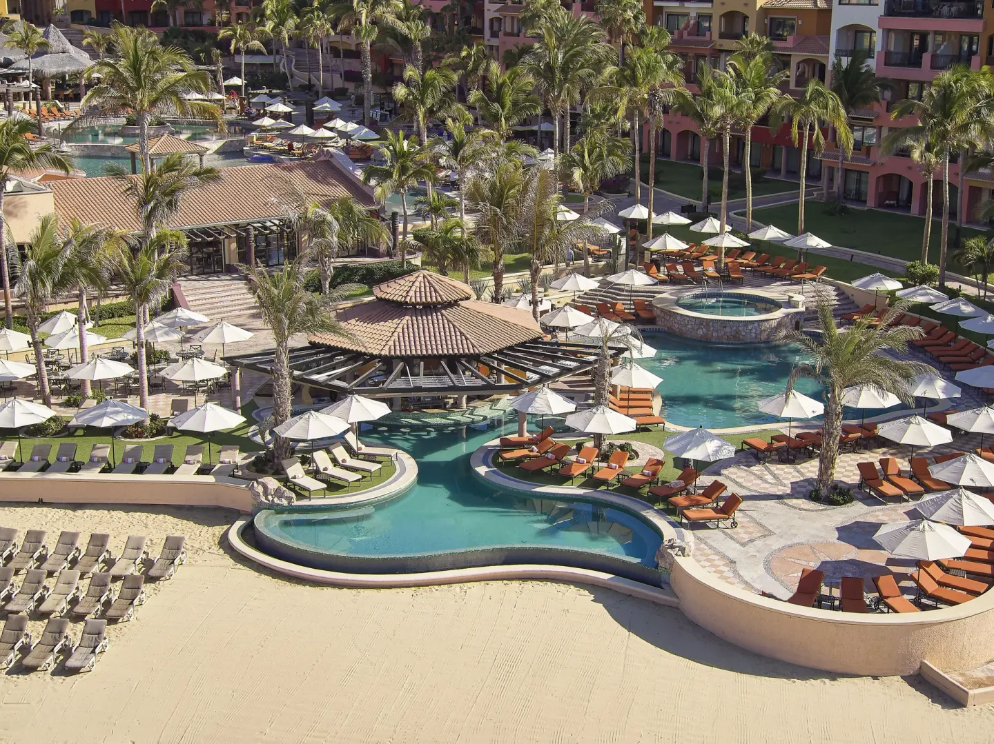 Aerial view of pools, palms, loungers and umbrellas at Playa Grande Resort & Grand Spa.