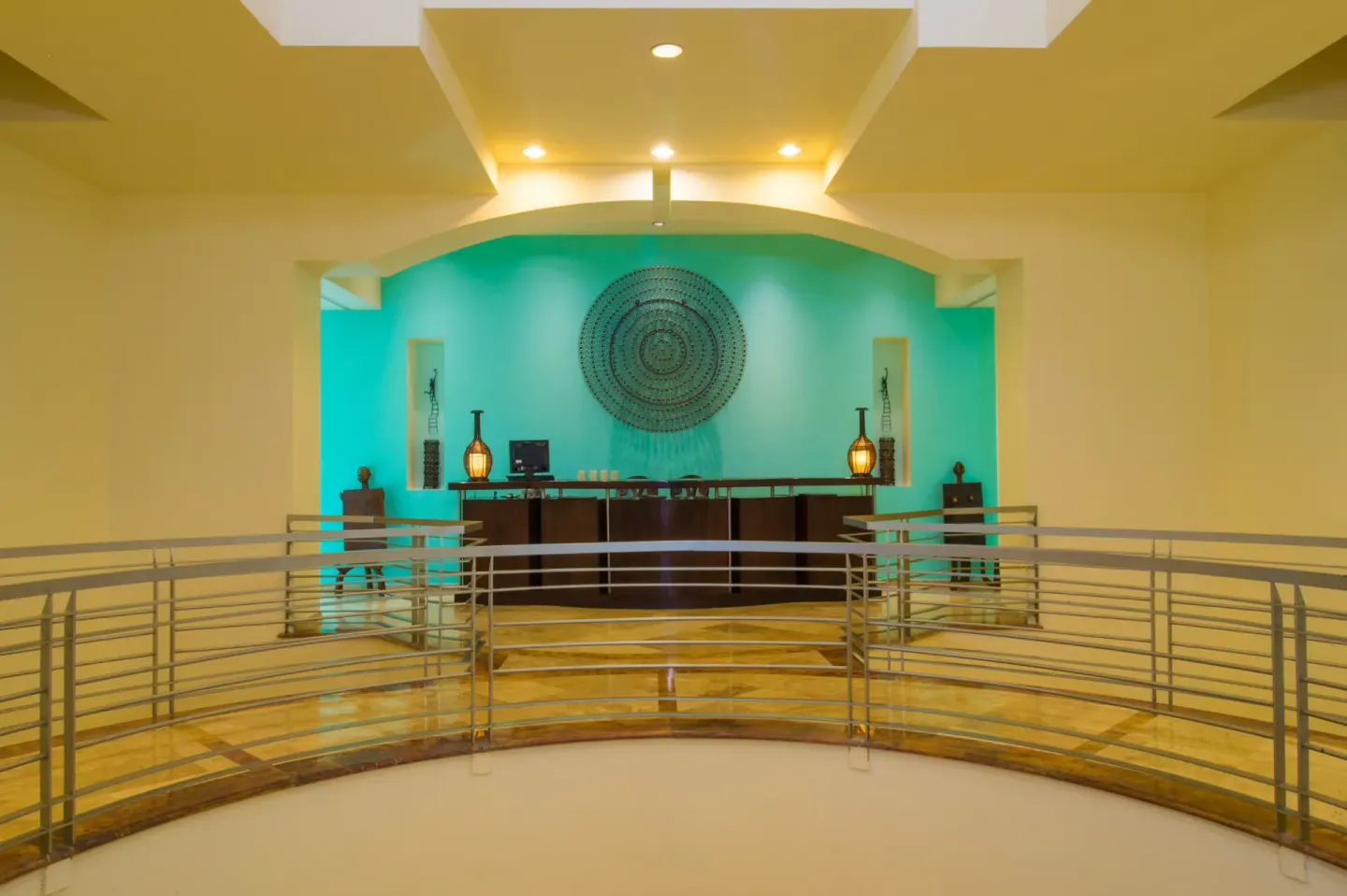 Spa reception desk with turquoise accent wall at Playa Grande Resort & Grand Spa.