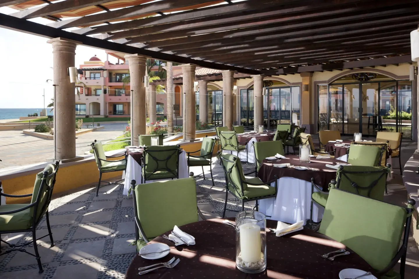 Covered outdoor restaurant terrace with ocean view at Playa Grande Resort & Grand Spa.