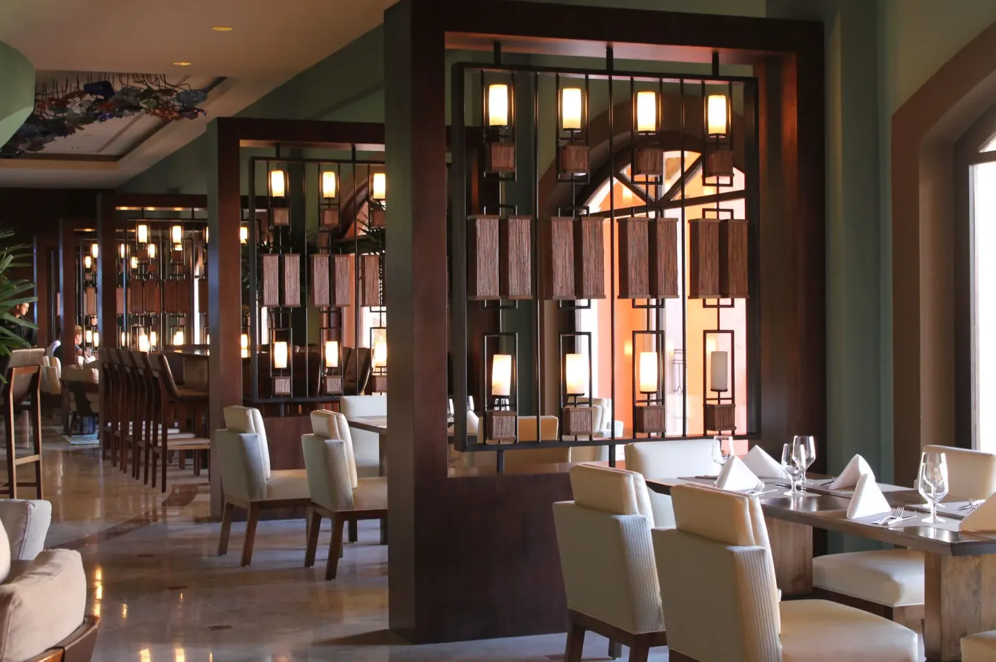 Elegant dining room with set tables at Playa Grande Resort & Grand Spa.