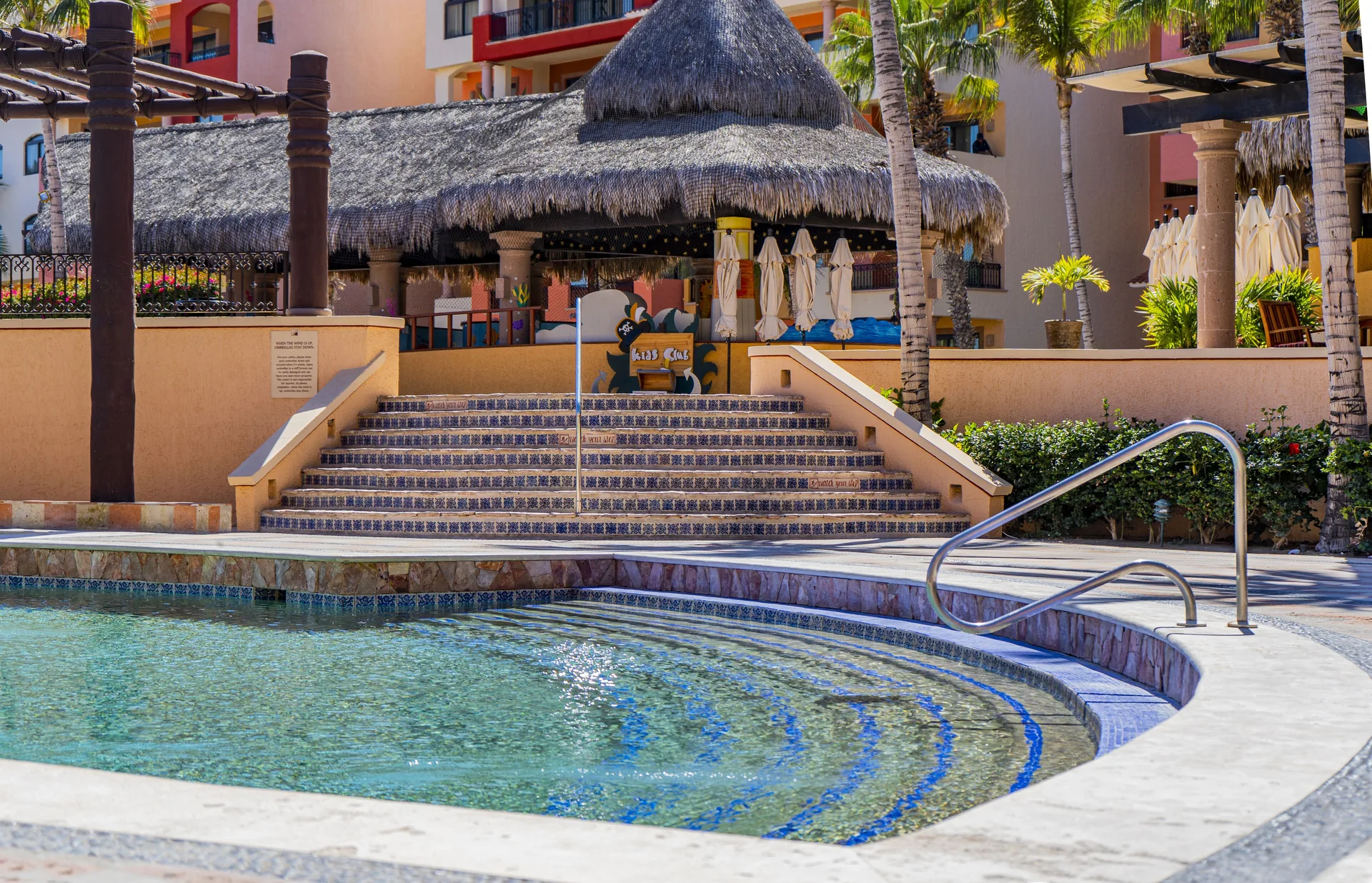 Pool steps leading toward La Taqueria at Playa Grande Resort & Grand Spa.