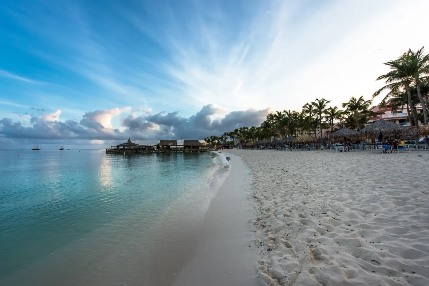 Calm beachfront with white sand and palms at Playa Linda Beach Resort.