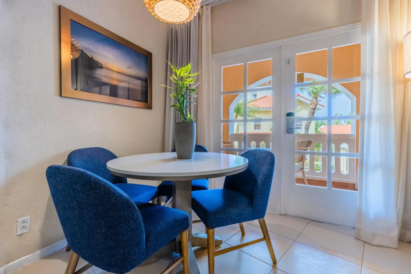 Round dining table by balcony doors in a room at Playa Linda Beach Resort.