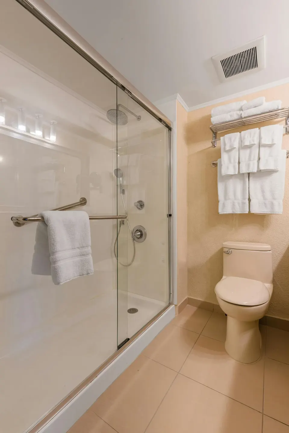 Walk-in rain shower with glass enclosure in the One Bedroom Suite at Playa Linda Beach Resort.