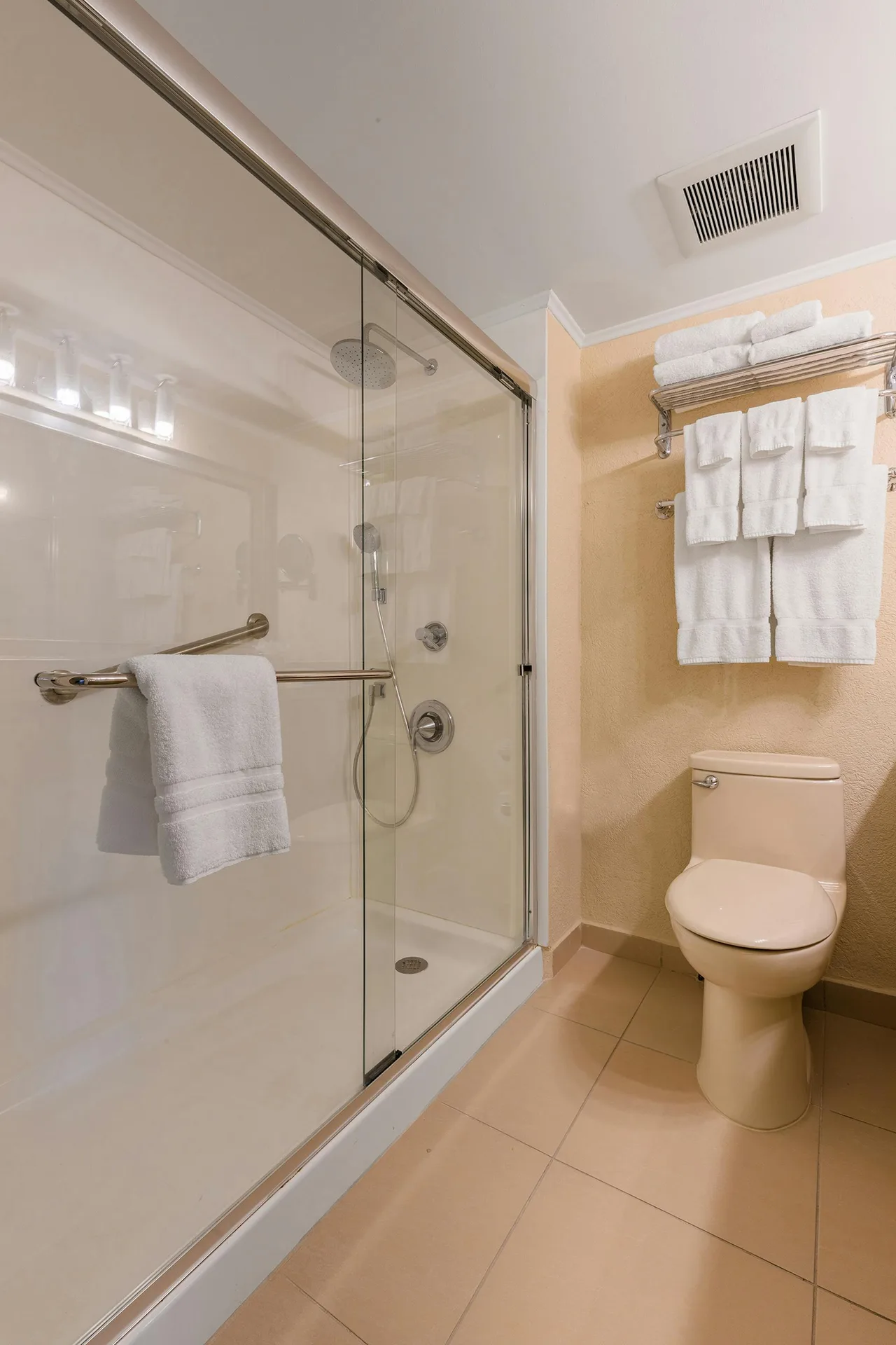 Walk-in rain shower with glass enclosure in the One Bedroom Suite at Playa Linda Beach Resort.