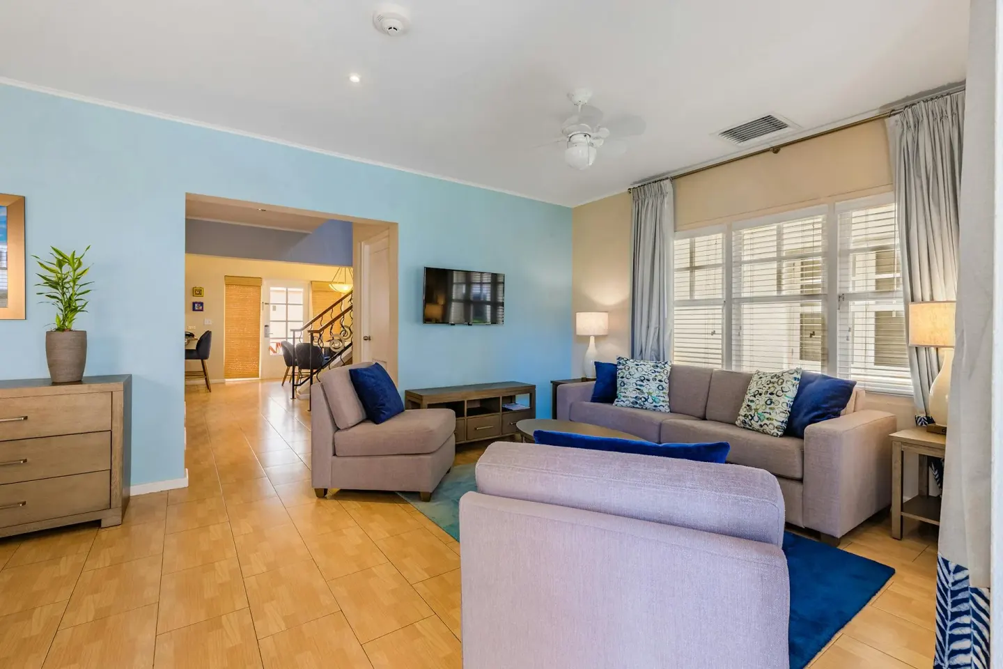 Family room with sectional seating and wall-mounted TV in the Townhouse Three Bedroom at Playa Linda Beach Resort.