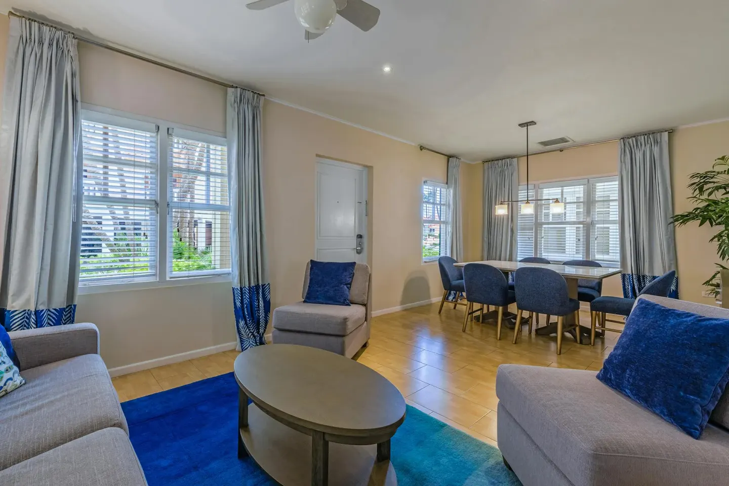 Open living and dining room with table for eight in the Townhouse Three Bedroom at Playa Linda Beach Resort.