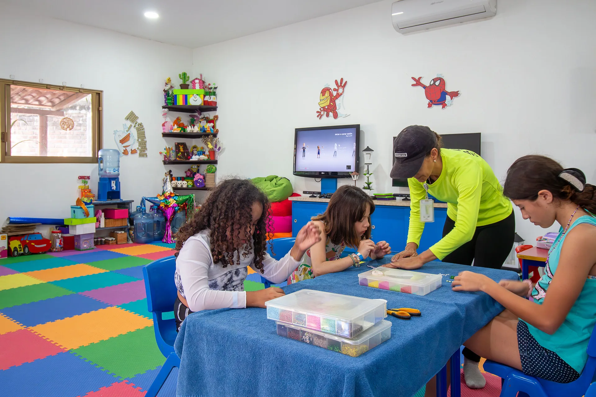 Children doing crafts with a staff member at Plaza Pelicanos Club Beach Resort.