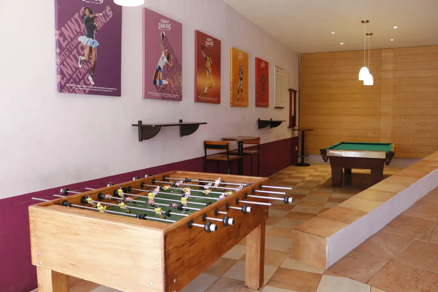Foosball and billiards tables sit in a recreation area at Plaza Pelicanos Club Beach Resort.