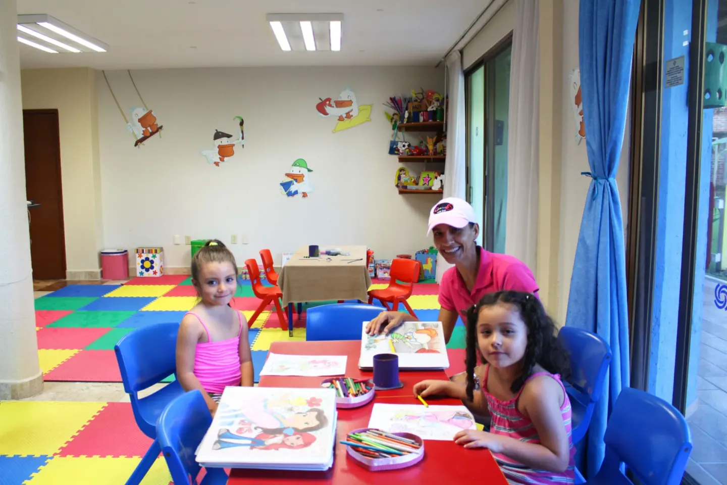 Children color at a kids club table at Plaza Pelicanos Club Beach Resort.