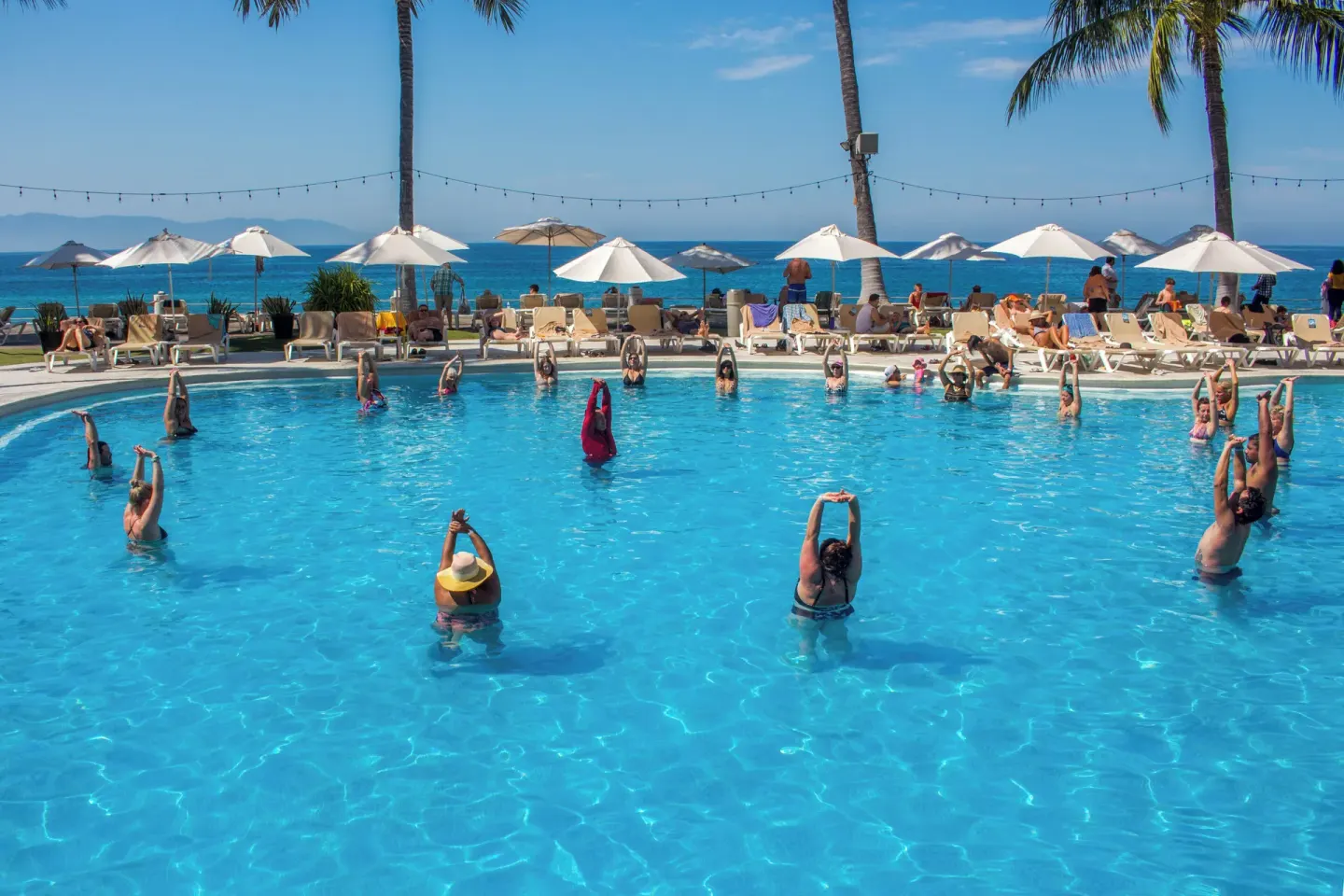 Pool aerobics class facing the ocean at Plaza Pelicanos Club Beach Resort.