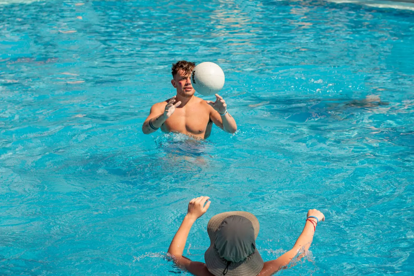 Guests tossing a ball in the pool at Plaza Pelicanos Club Beach Resort.