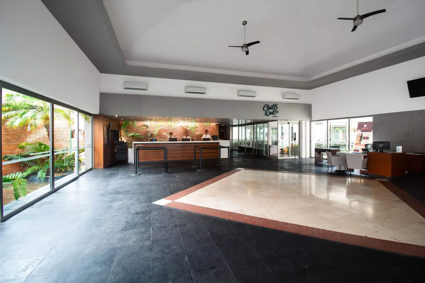 Wide lobby view with reception desk and seating at Plaza Pelicanos Club Beach Resort.