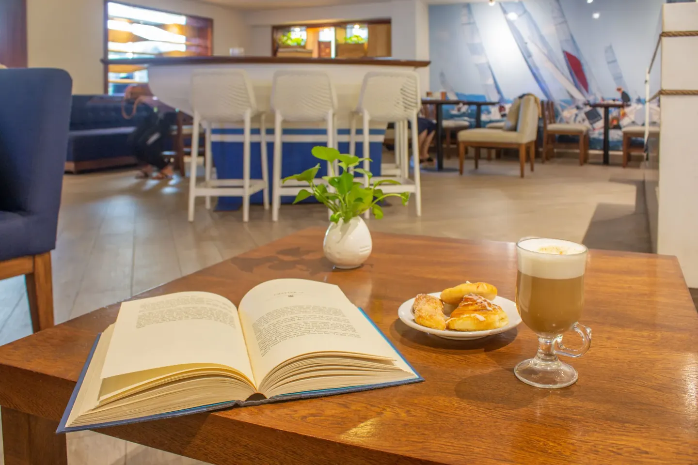 Coffee, pastries, and an open book in the cafe at Plaza Pelicanos Club Beach Resort.