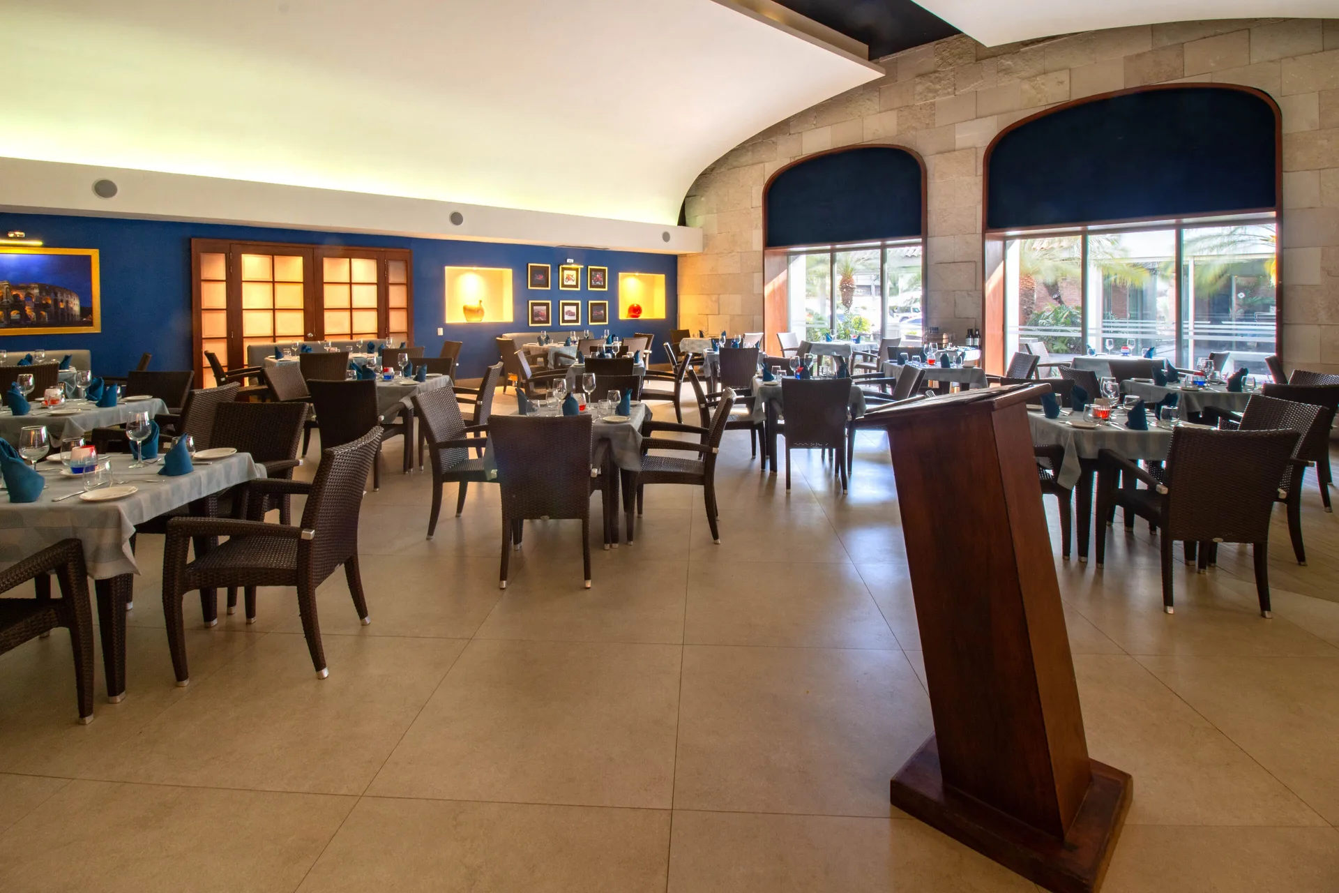 Dining room with podium and set tables at Plaza Pelicanos Club Beach Resort.