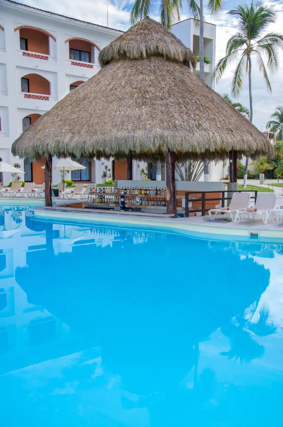 Thatched swim-up pool bar at Plaza Pelicanos Club Beach Resort.