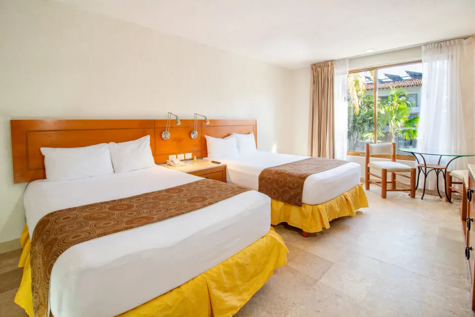 Standard Room with two beds and window seating at Plaza Pelicanos Club Beach Resort.