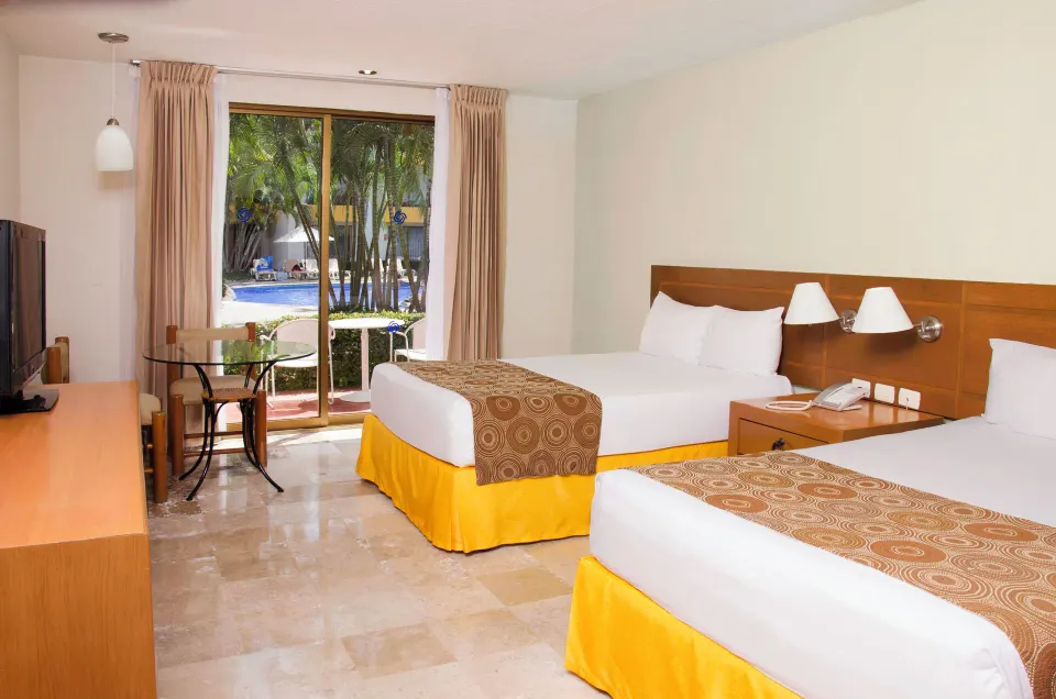 Standard room with two double beds and pool view at Plaza Pelicanos Club Beach Resort.