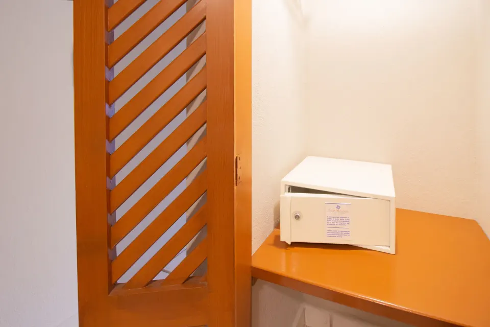 One-bedroom suite closet area with in-room safe at Plaza Pelicanos Club Beach Resort.