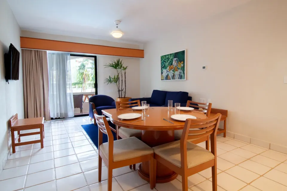 One-bedroom suite dining and lounge area at Plaza Pelicanos Club Beach Resort.