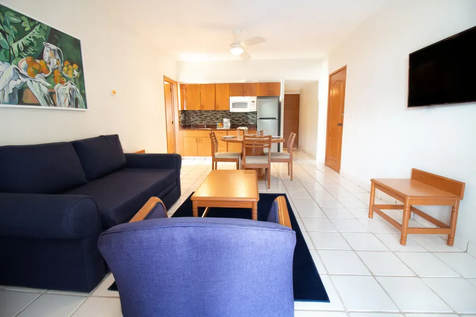 One-bedroom suite living area with kitchenette at Plaza Pelicanos Club Beach Resort.