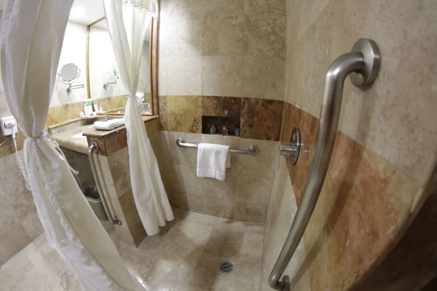 Superior room bathroom shower with grab bars at Plaza Pelicanos Club Beach Resort.