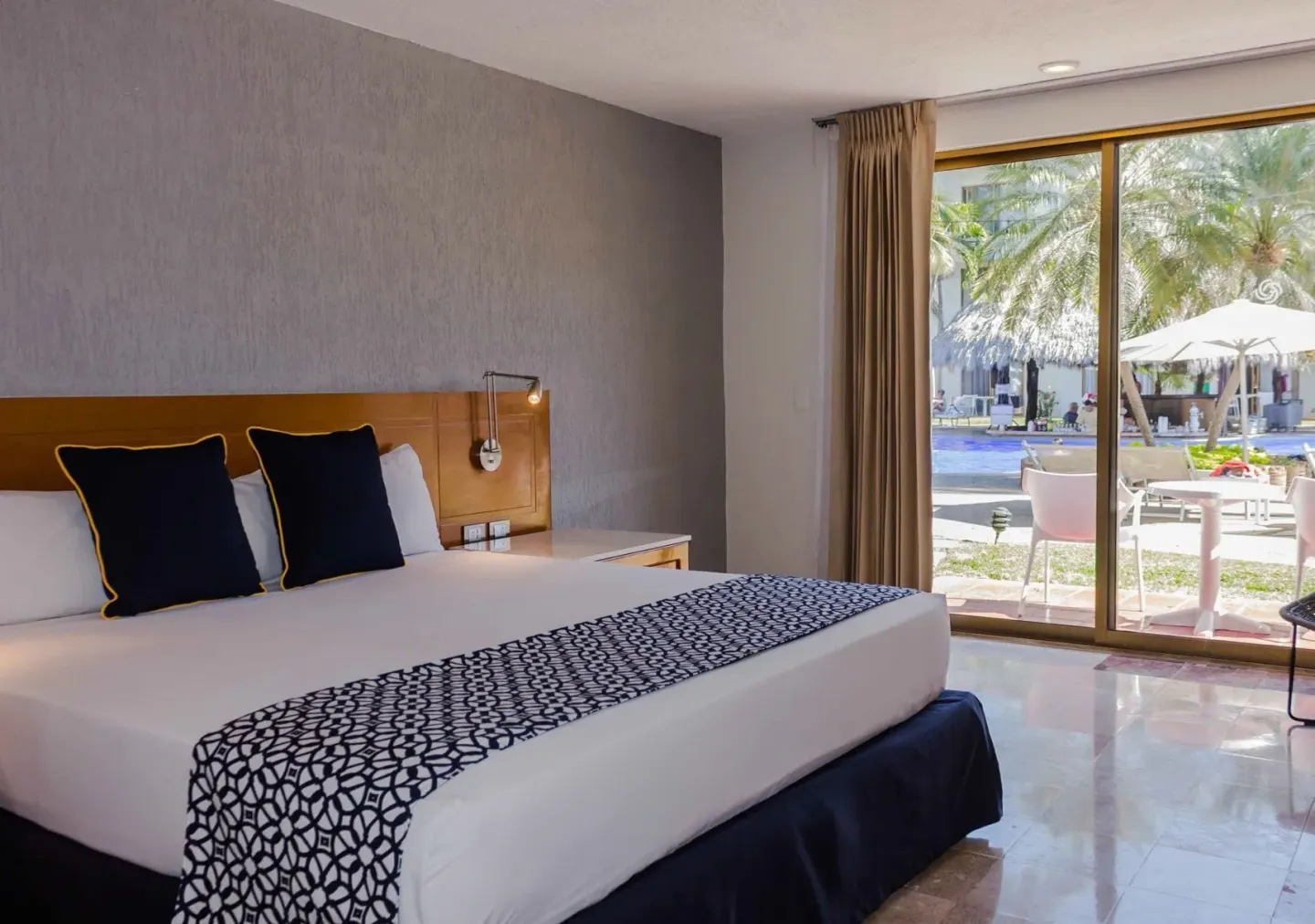 Superior room with king bed and terrace pool view at Plaza Pelicanos Club Beach Resort.