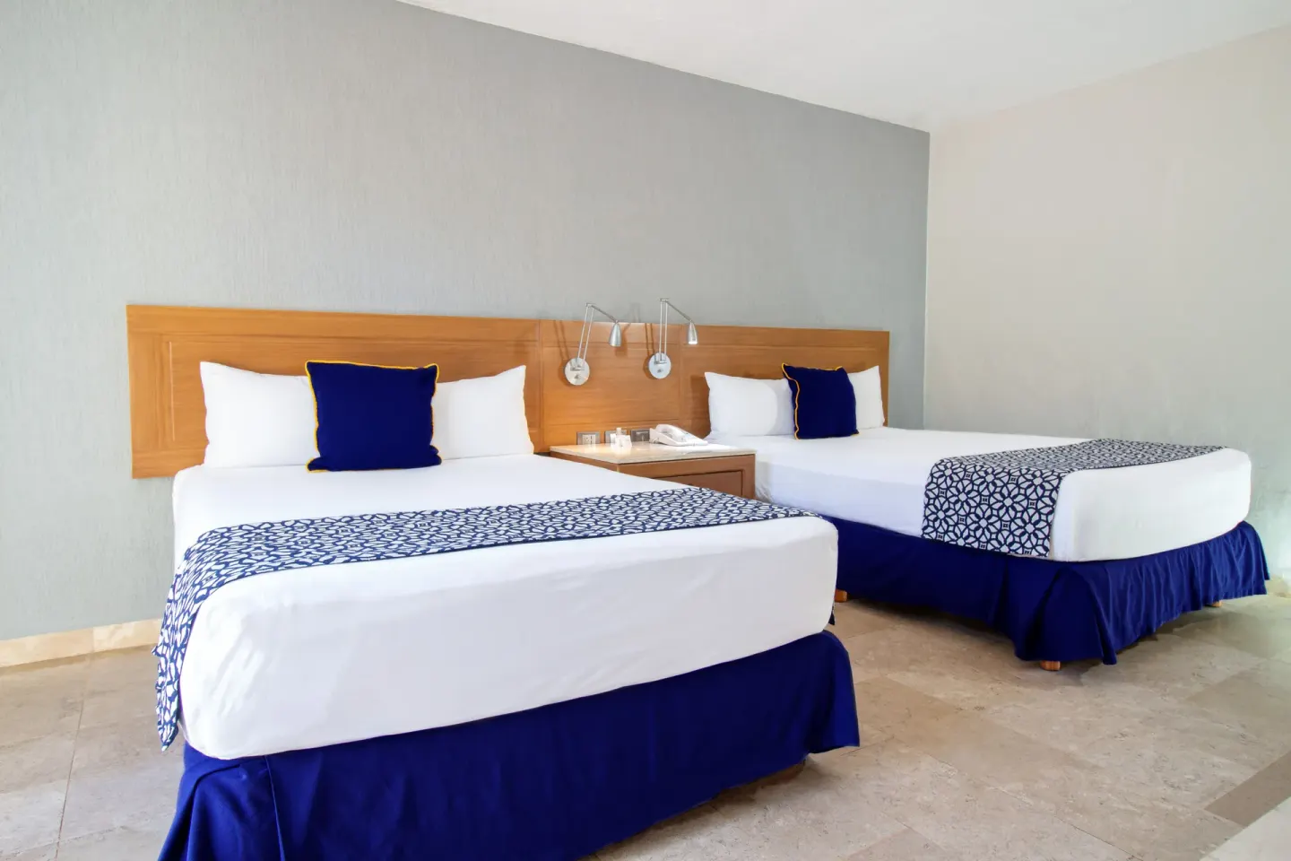Superior Room with two beds and bedside lamps at Plaza Pelicanos Club Beach Resort.