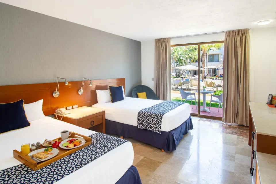 Superior Room with two beds and patio view at Plaza Pelicanos Club Beach Resort.