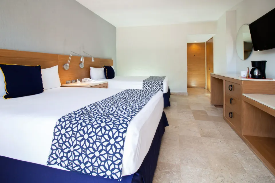 Superior Room with two beds and dresser along the side wall at Plaza Pelicanos Club Beach Resort.