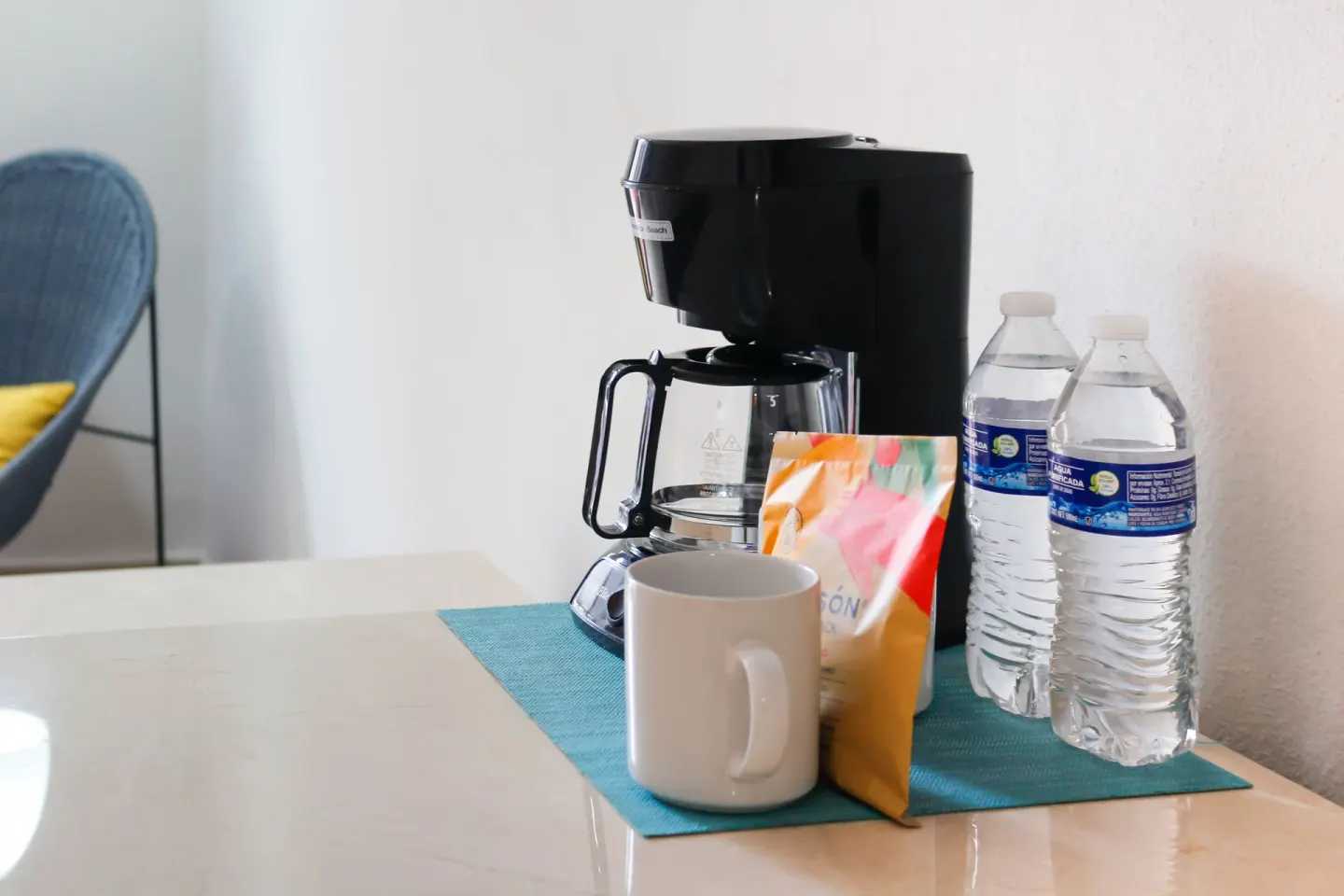 Superior room coffee maker, mug, and bottled water at Plaza Pelicanos Club Beach Resort.