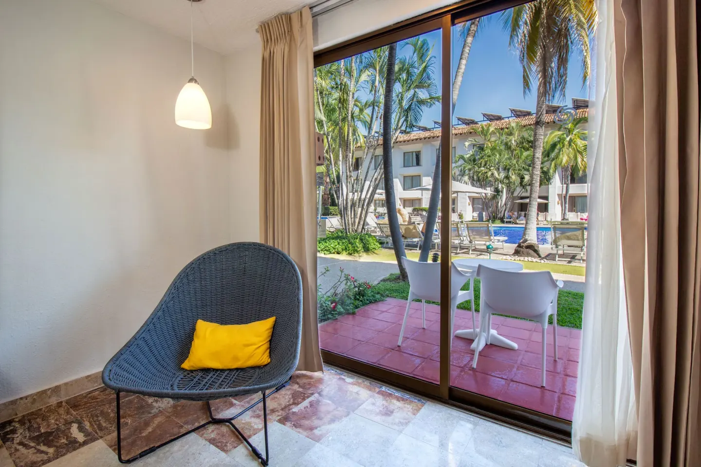 Superior room seating area and patio view at Plaza Pelicanos Club Beach Resort.