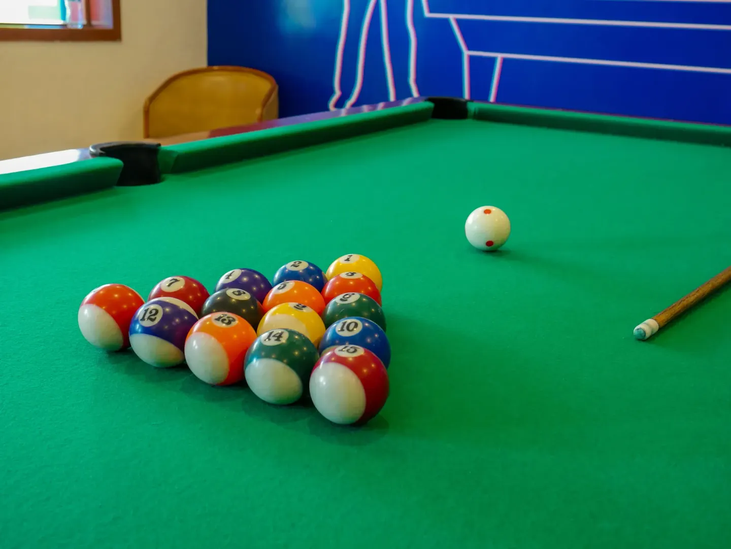 Close-up of billiard balls on a green pool table at Plaza Pelicanos Grand Beach Resort.