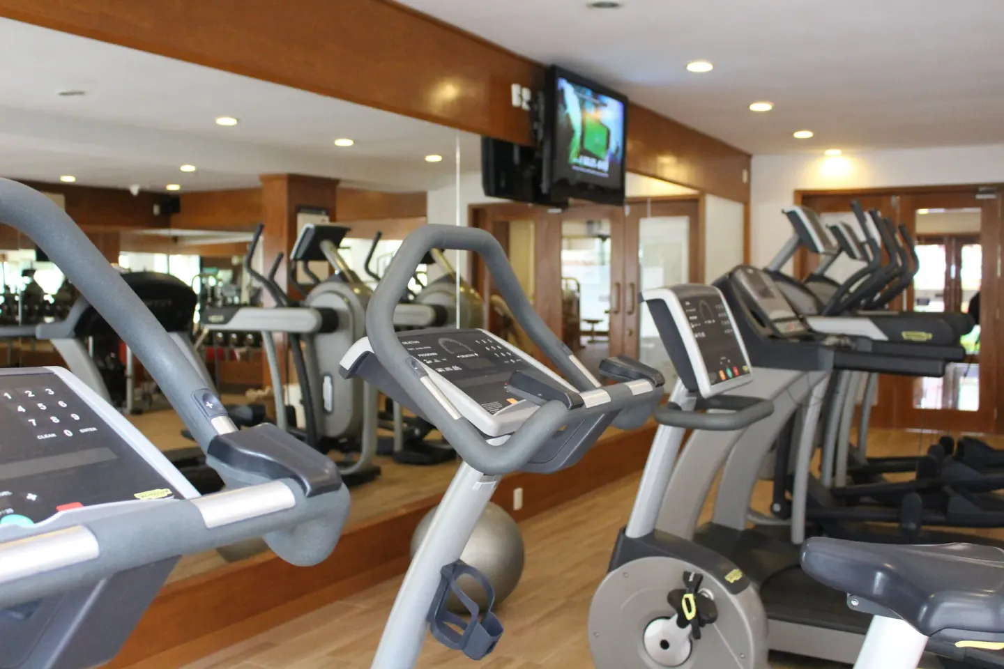 Fitness room with cardio machines at Plaza Pelicanos Grand Beach Resort.