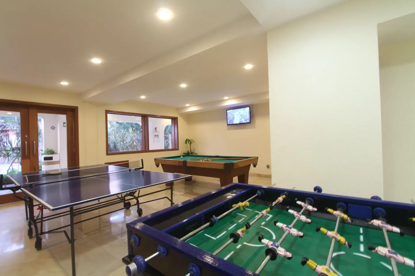 Game room with foosball, table tennis and billiards at Plaza Pelicanos Grand Beach Resort.
