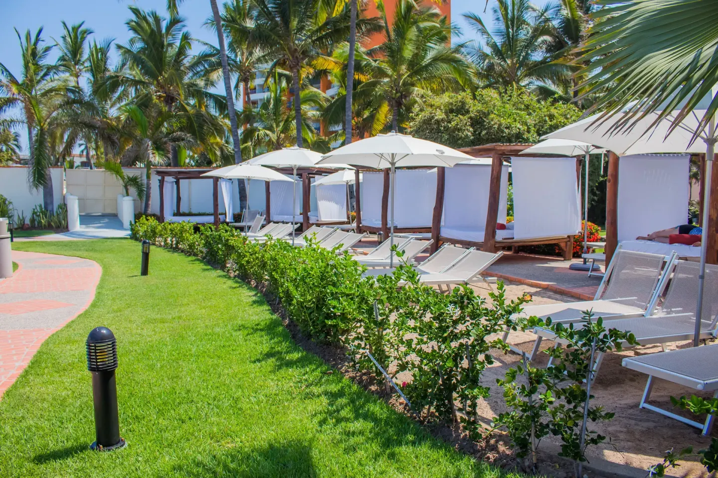 Garden cabanas and loungers at Plaza Pelicanos Grand Beach Resort.