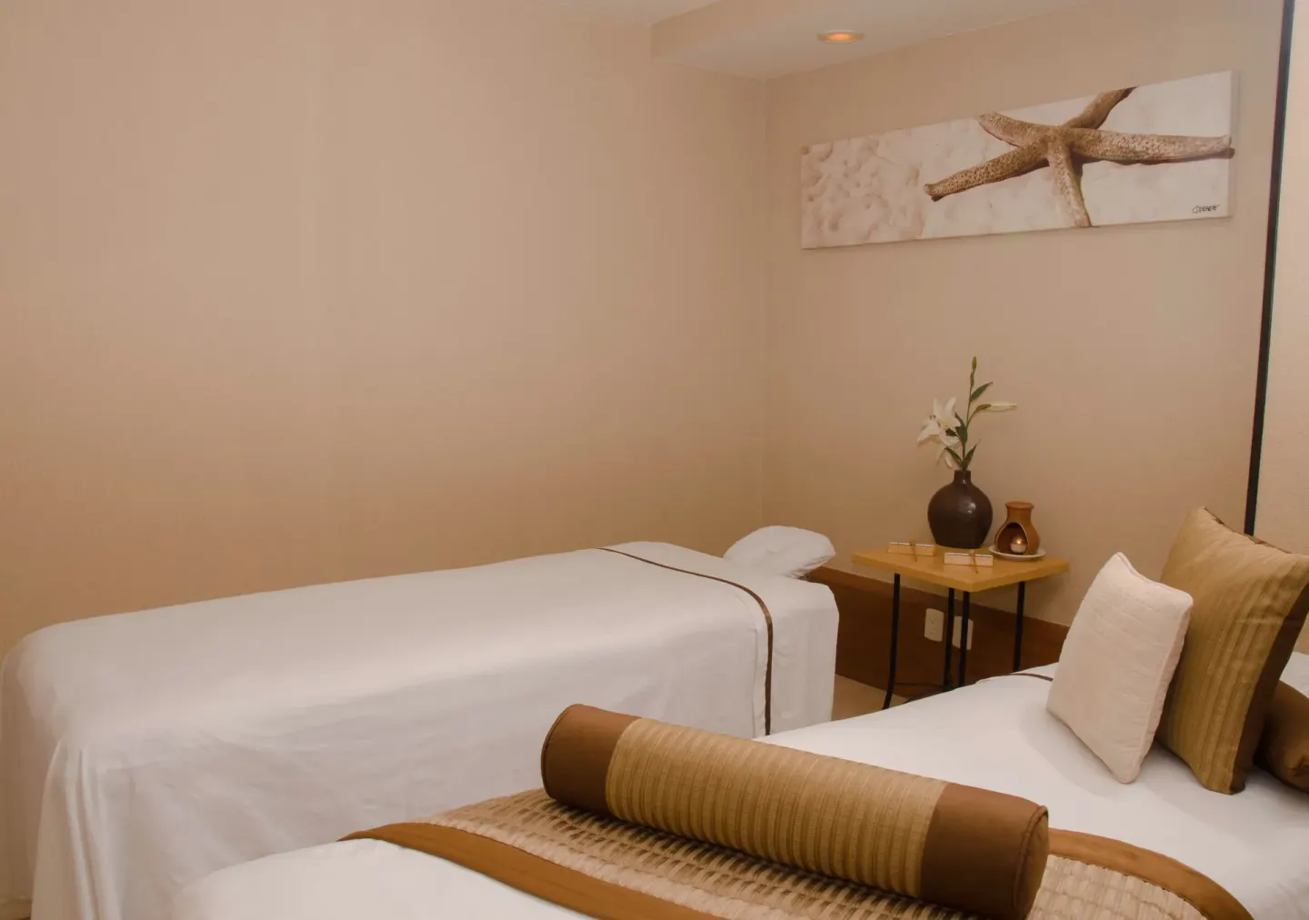 Spa treatment room with two massage beds at Plaza Pelicanos Grand Beach Resort.