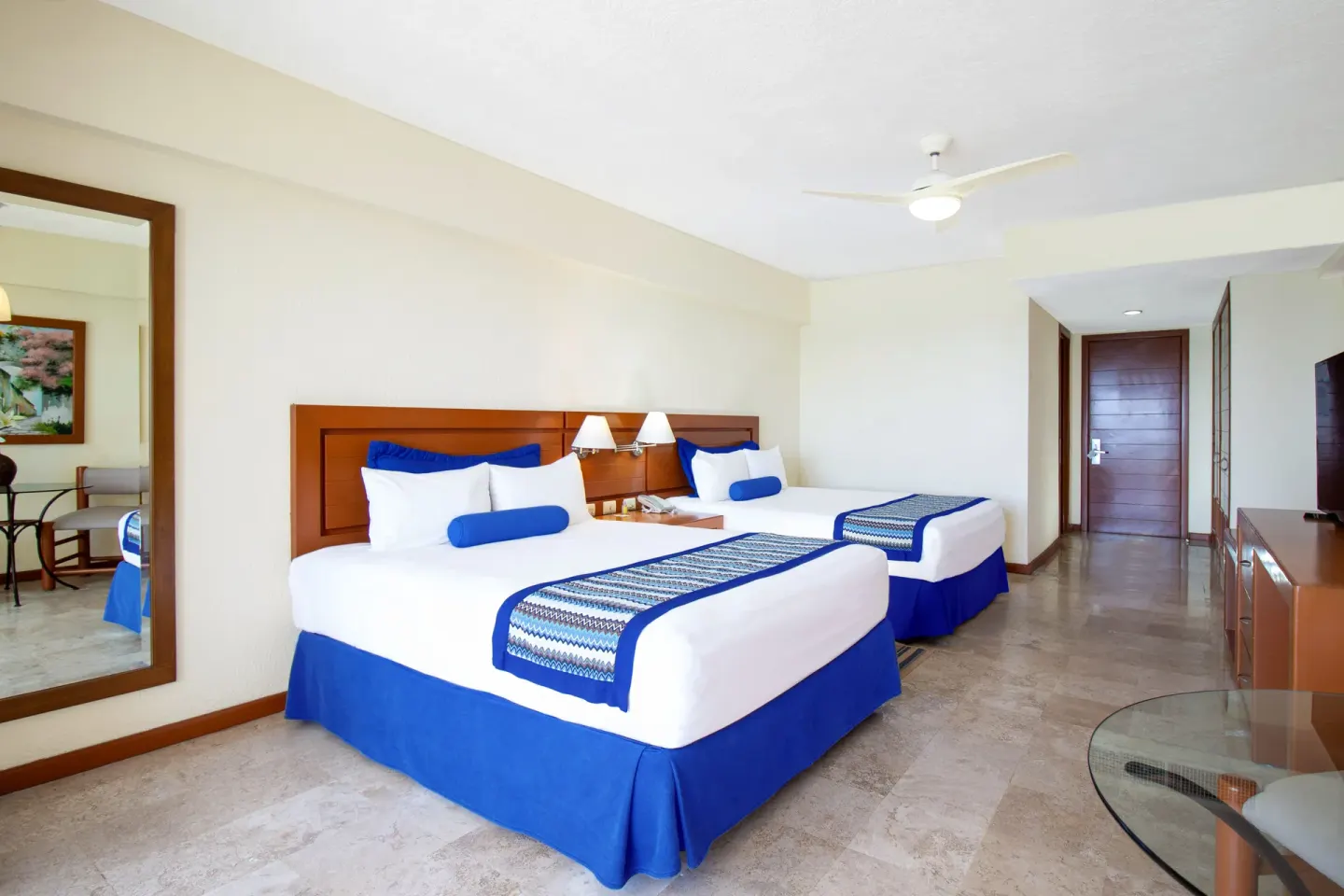 Two beds in a family suite bedroom at Plaza Pelicanos Grand Beach Resort.