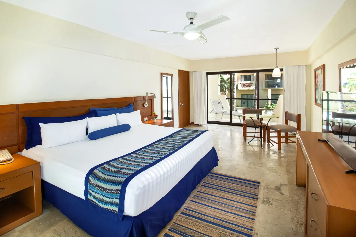 One Bedroom Suite king bed and balcony at Plaza Pelicanos Grand Beach Resort.