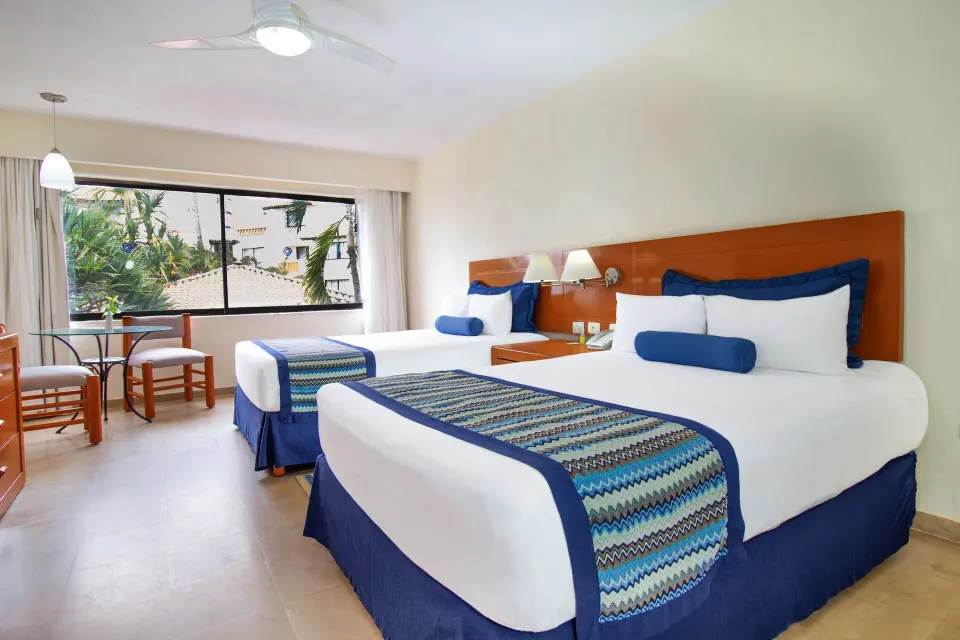 Standard Room with two beds and window seating at Plaza Pelicanos Grand Beach Resort.