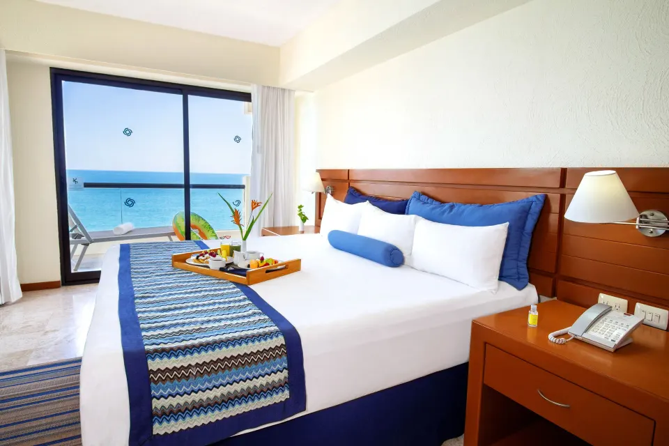 Ocean-view king bedroom in a Two Bedroom Family Suite at Plaza Pelicanos Grand Beach Resort.