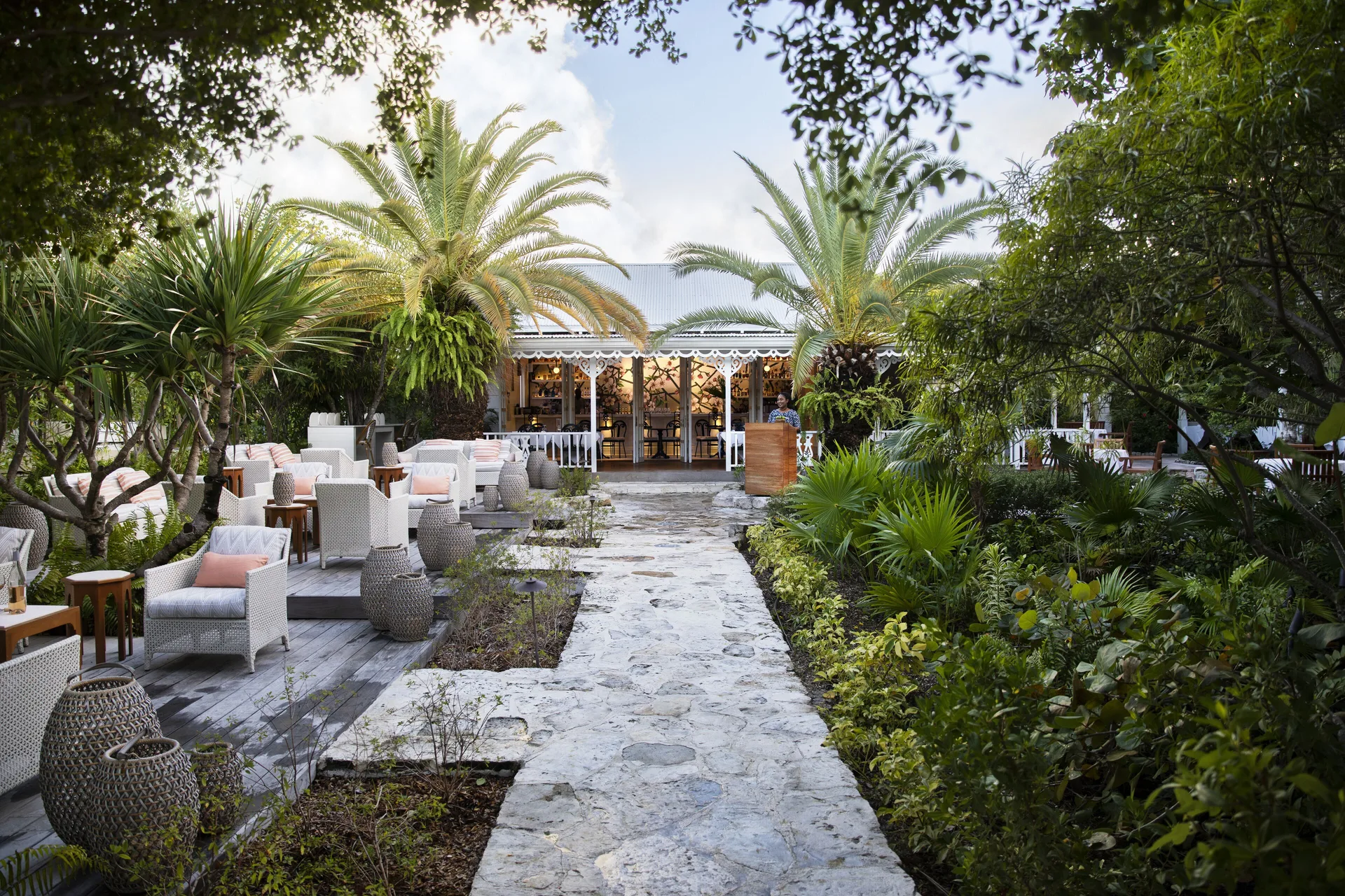 Stone garden path leading to a bar and outdoor seating at Point Grace.
