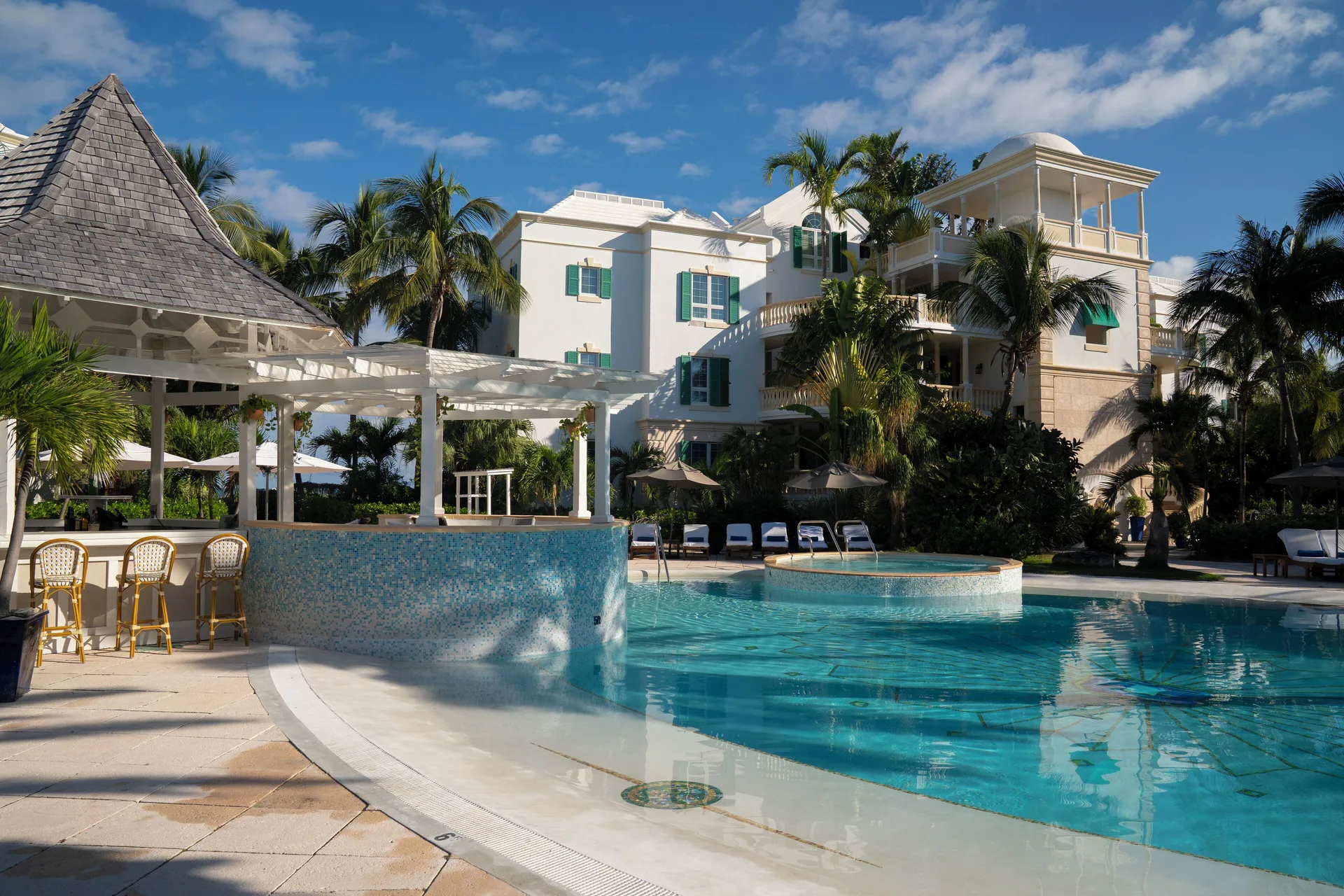 Pool bar beside the swimming pool and resort buildings at Point Grace.