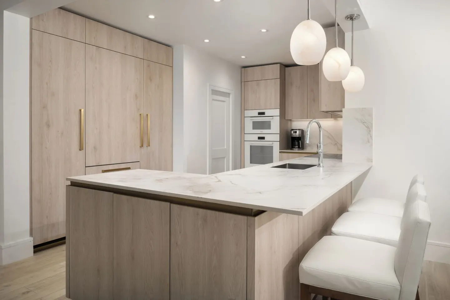 Oceanfront three-bedroom luxury suite kitchen with island seating at Point Grace.